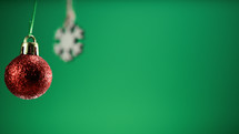 Red ball and snowflake decoration with green background