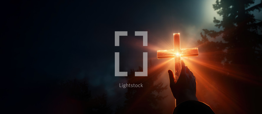 Hand reaching for the cross with light rays on a night background 