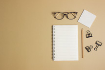 notebook and reading glasses on a desk 