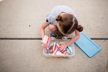 a girl with sidewalk chalk 