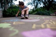 child coloring with sidewalk chalk 