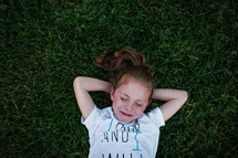 a girl resting in grass