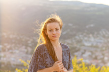 Young woman in a dress at sunset. Rhone valley in the background.