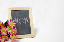 yellow and pink flowers and chalkboard with the word mom 