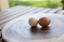 two eggs on a cutting board 