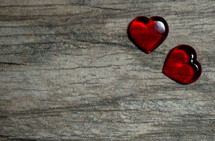 red hearts on a wood background 