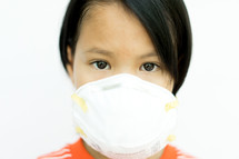 girl child wearing a protective face mask 