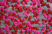 red and pink hearts on a wood background 