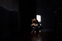sky scared child sitting in a dark room 