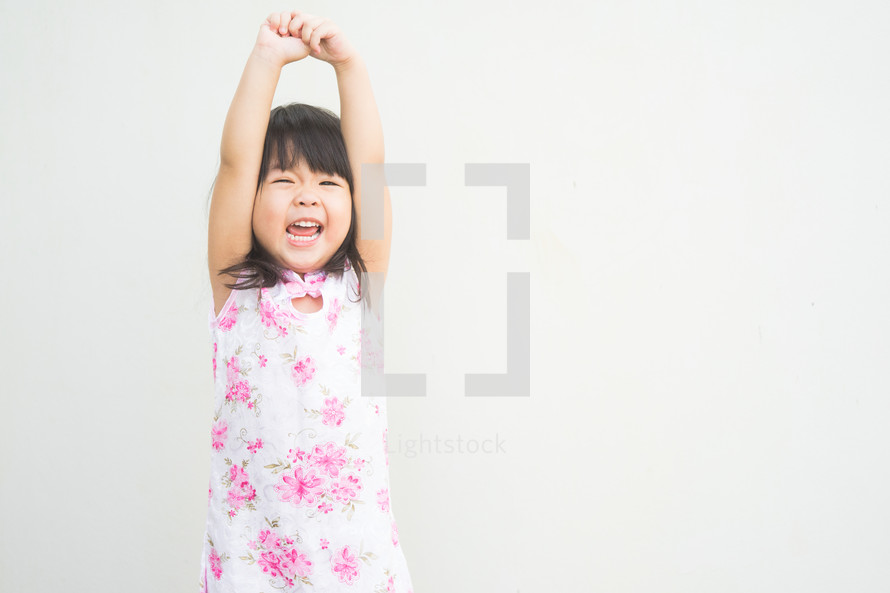 a girl reaching up 
