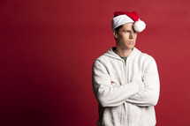 man in a santa hat pouting 