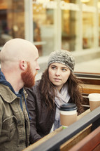 a couple talking over coffee 