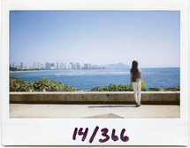 Polaroid of a woman standing at the shore 