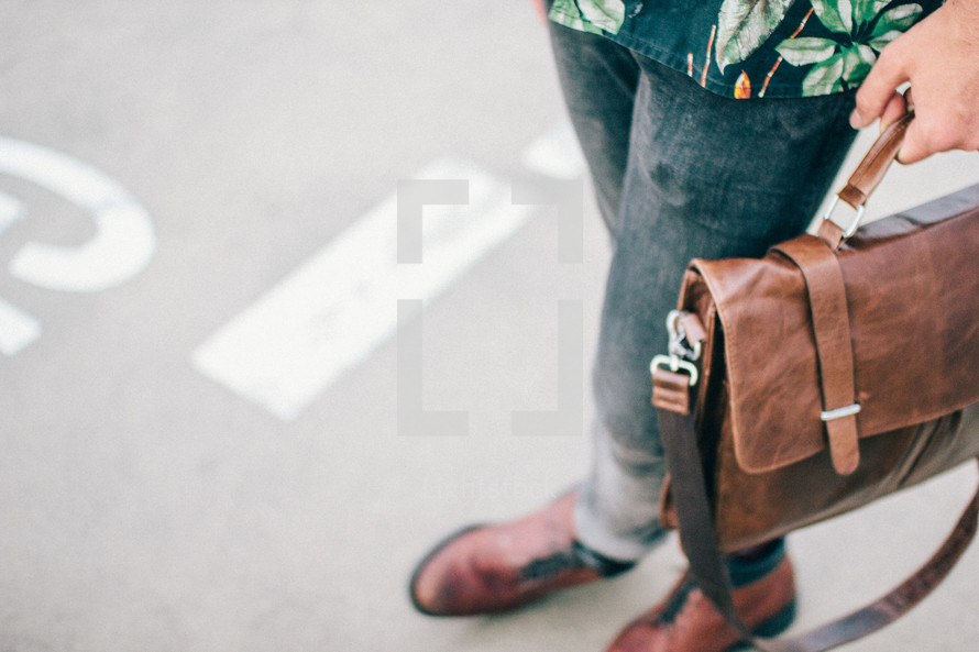man with a leather satchel 