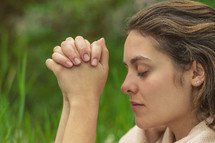 a young woman praying 