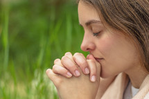 a young woman praying 