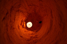 inside a jack o lantern. candle inside a carved out pumpkin.