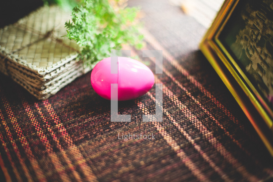a plastic Easter egg on a table cloth 