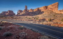 red rock cliffs and peaks along a highway 