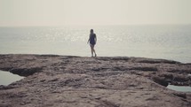person walking on a shore 