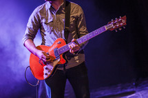 a guitarist on stage 
