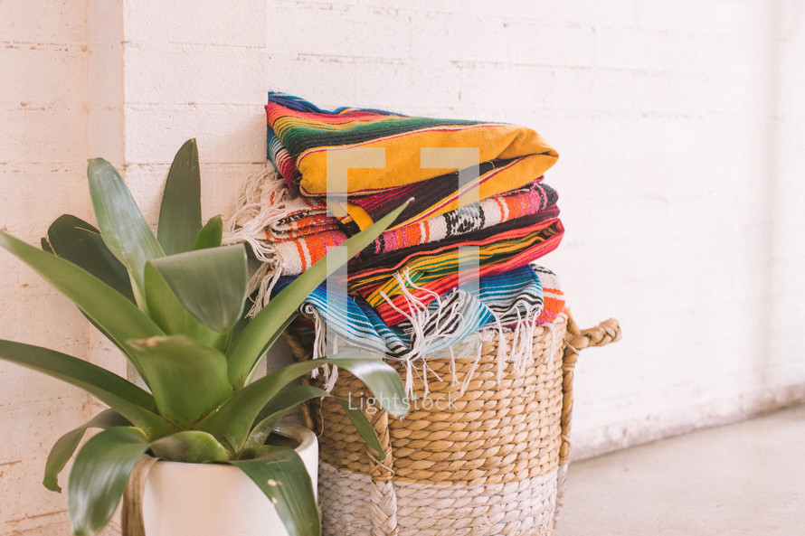 folded blankets in basket 