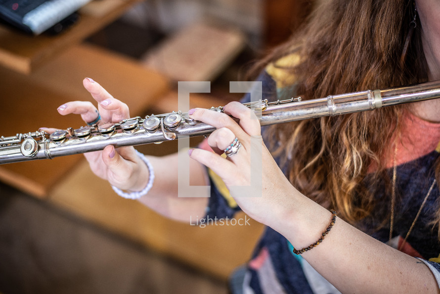 a girl playing a flute 