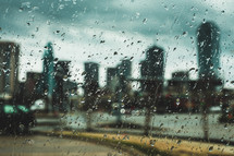 rain on a window and view of a city 