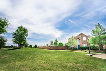green grass in a front yard and brick house 