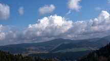 Clouds moving over Spruce mountains in Spring landscape Timelapse