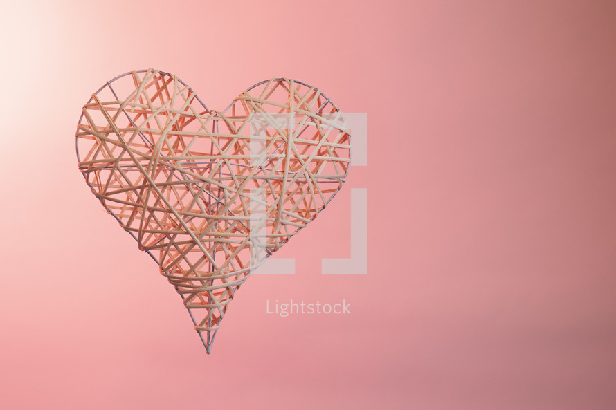 3D  wooden frame heart with a pink background