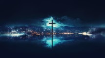 Cross in the fog with city lights at night.