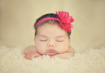 a newborn girl sleeping 