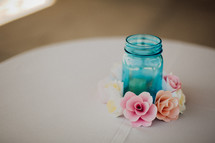 flowers around a blue mason jar 