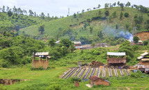 huts and farm land in a village 