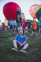 happy child at a hot air balloon festival 