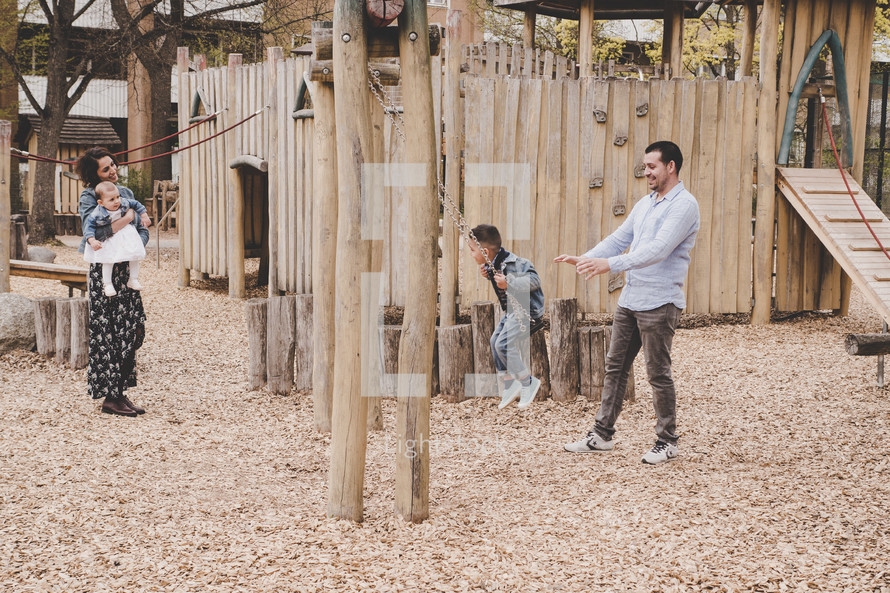 family playing on a playground 