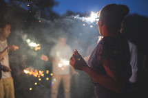 teens around smoke and fireworks at night 