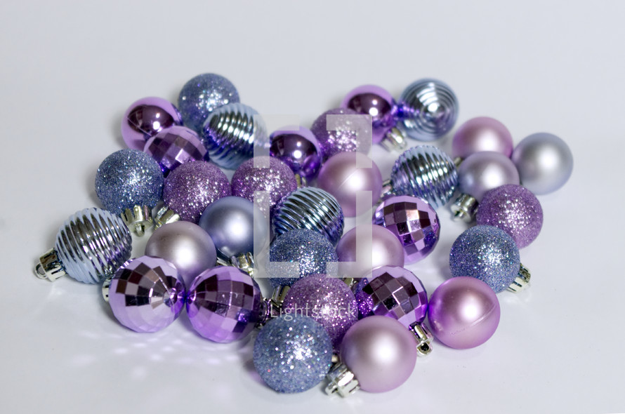 purple, pink, and blue Christmas ornaments 