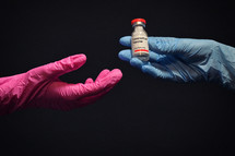Woman Hand With Glove Holding Coronavirus Vaccine