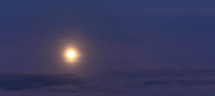 glowing moon in the sky above the clouds 