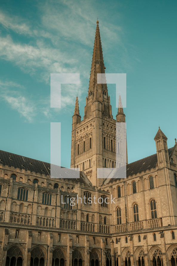 Norwich Cathedral spire, beautiful historic building, stunning architecture, tall tower place of worship blue sky