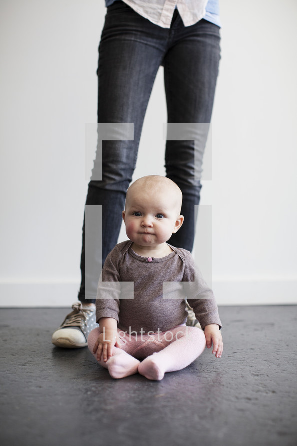 mother's legs and infant girl 