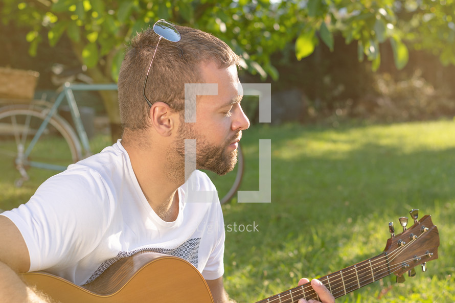 man strumming a guitar 