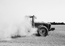 tractor stirring up dust 