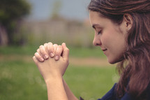 a young woman in prayer