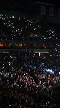 Audience with lighters held in the air.