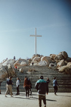 group of people around a cross