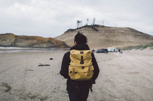 man backpacking on a beach 