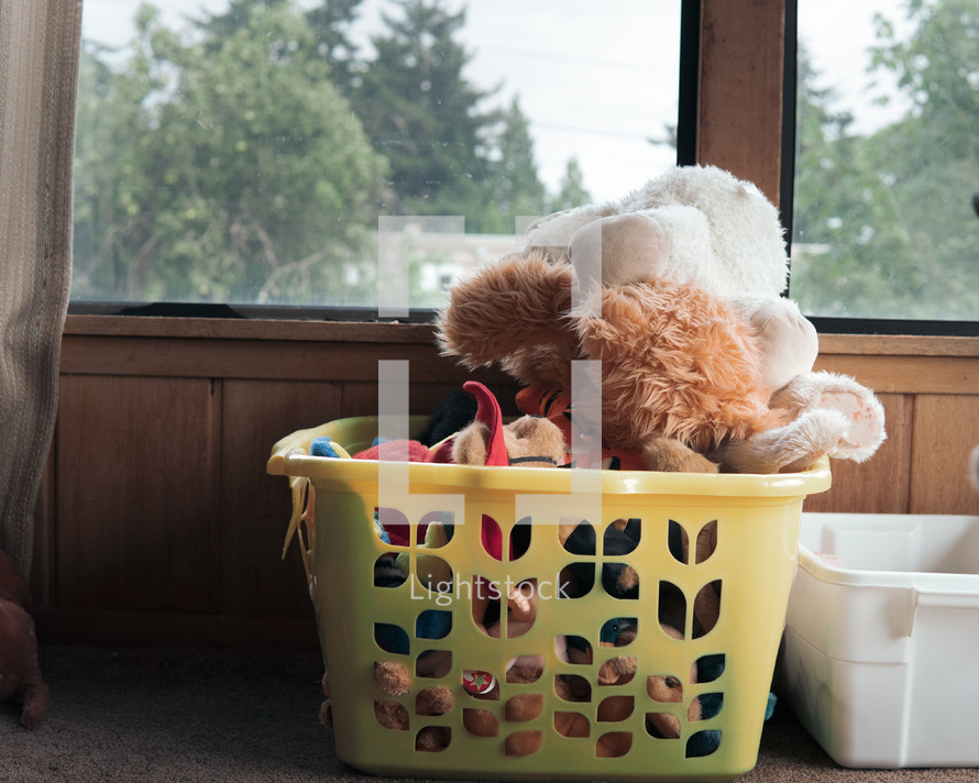laundry basket full of stuffed animals 